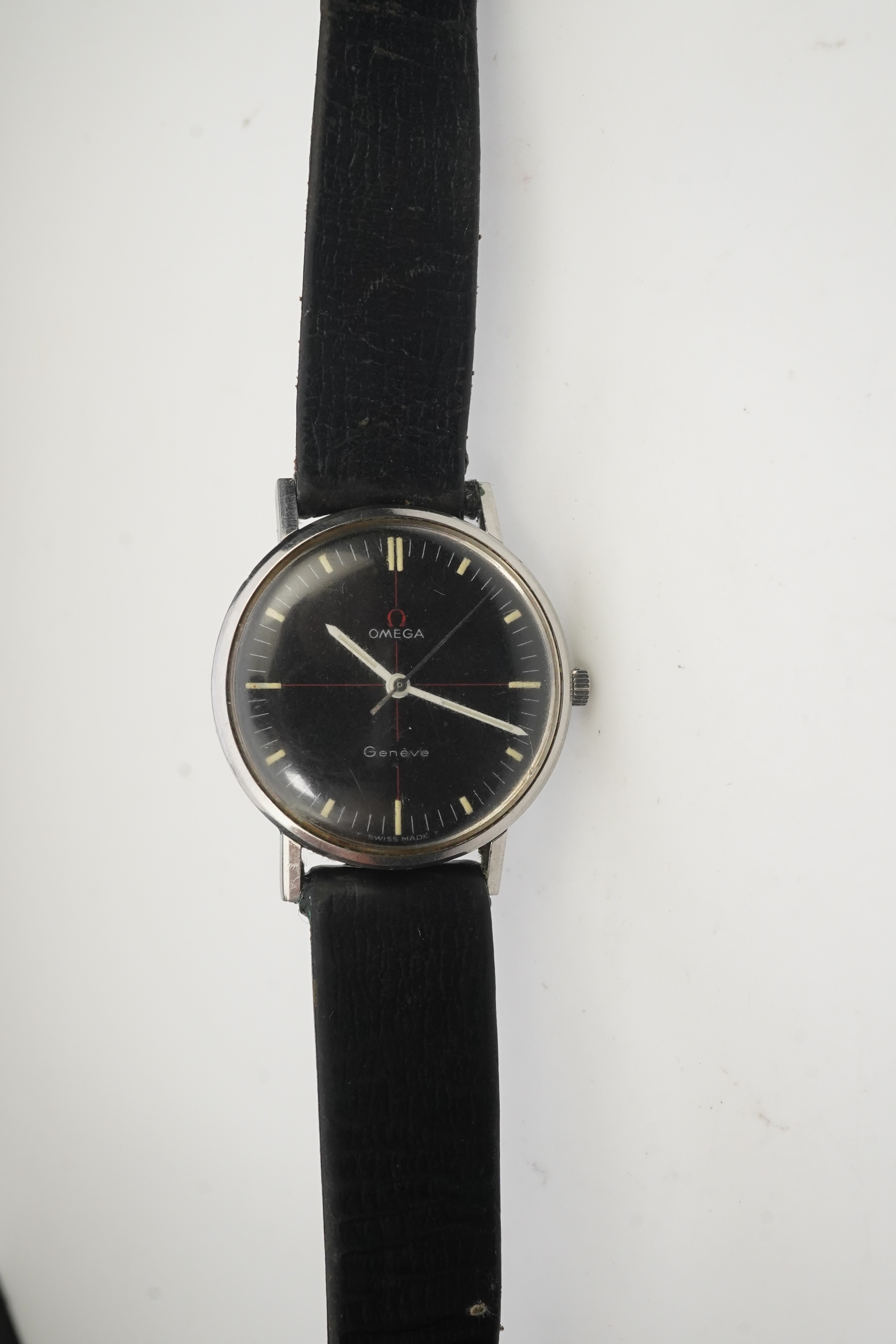 A gentleman's late 1960's/early 1970's stainless steel Omega manual wind wrist watch, the black dial with red cross-hair and baton numerals